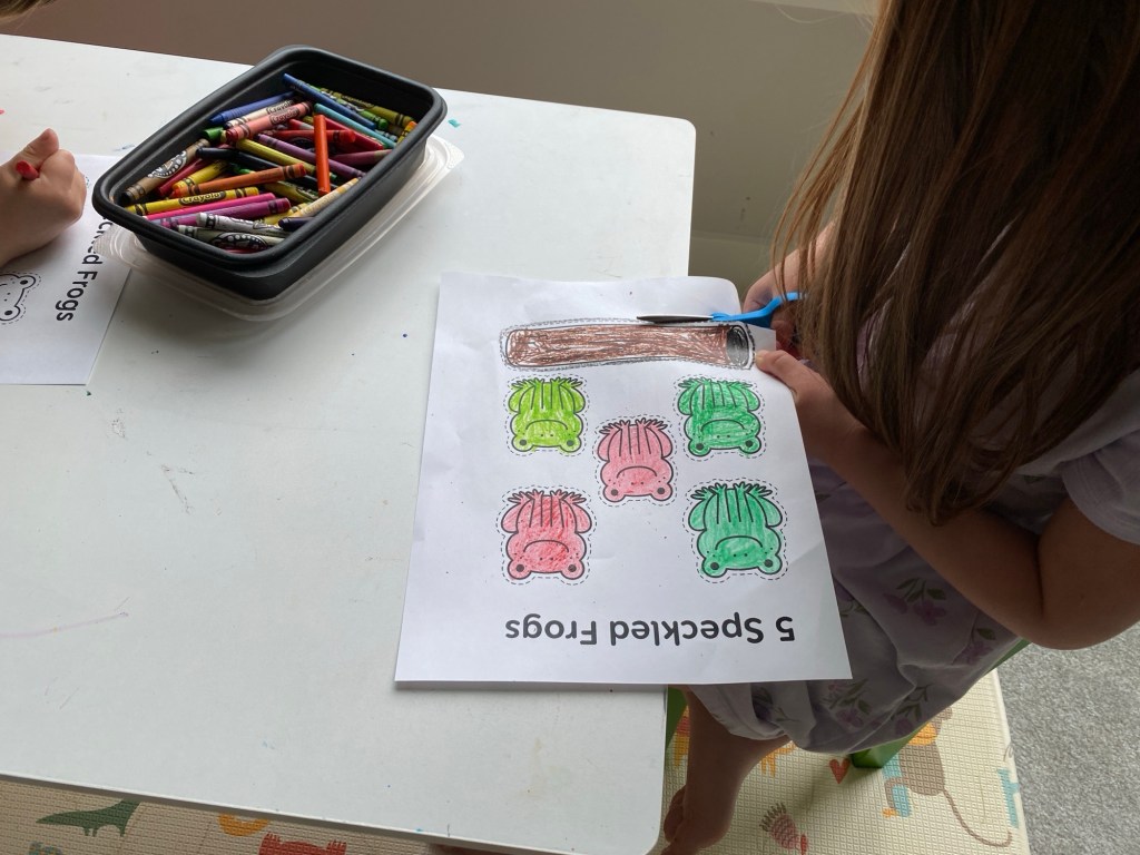 kids cutting out frogs activity
