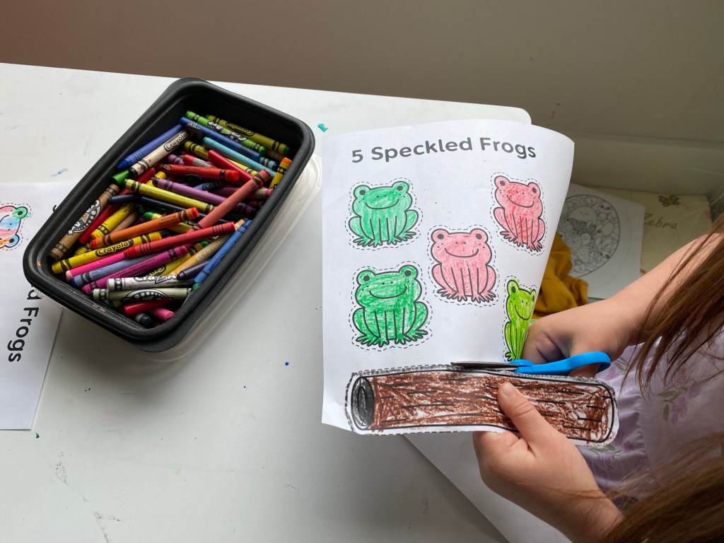 cutting out each of the frogs