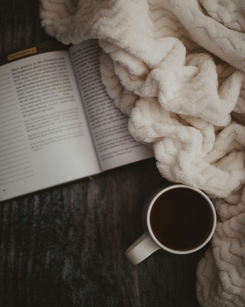 self-care is relaxing with a book, warm blanket, coffee or tea